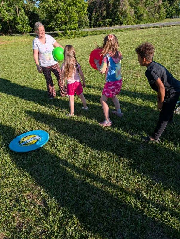 Kids playing with balloons outdoors